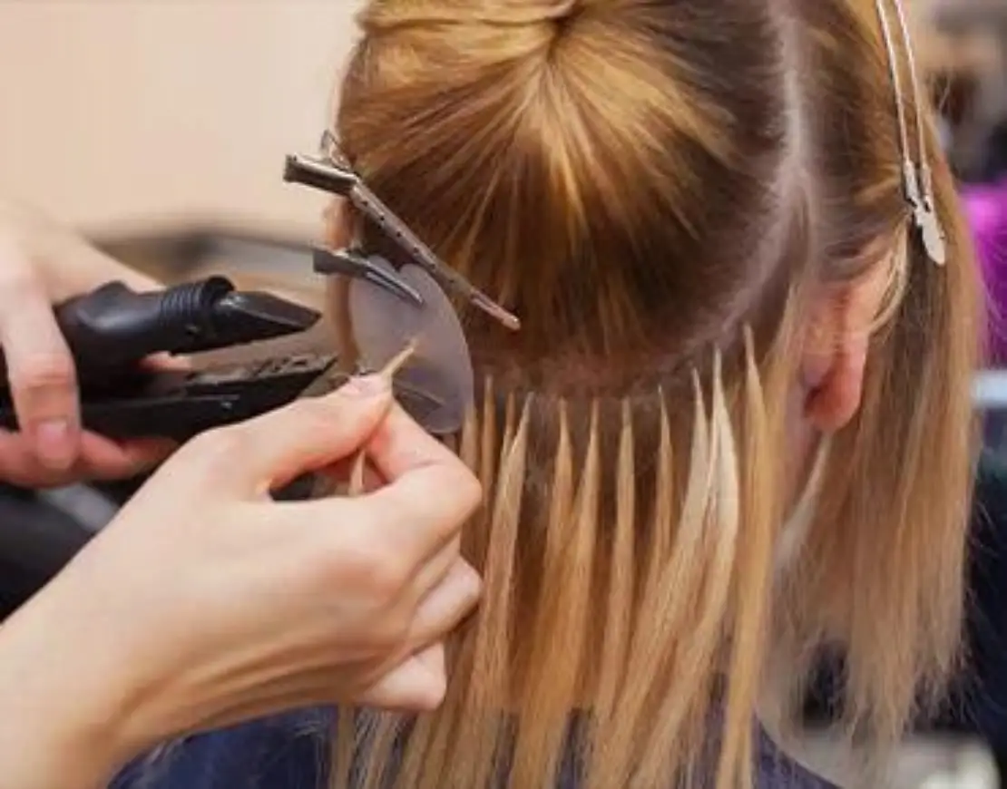 Woman styling another woman's hair