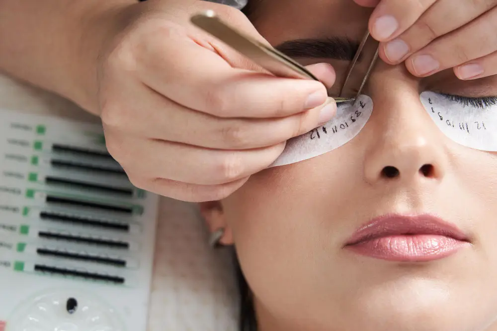 Woman getting eyelash extension treatment