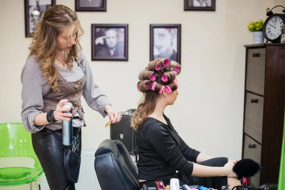 A woman styling another woman's hair